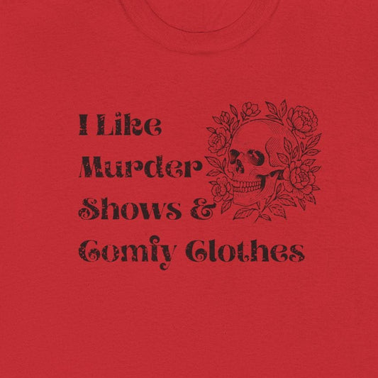 A red short-sleeve crewneck t-shirt with a black graphic print on the front that reads 'I Like Murder Shows & Gomf Clothes' alongside a skull and crossbones design, shown on a plain white background.