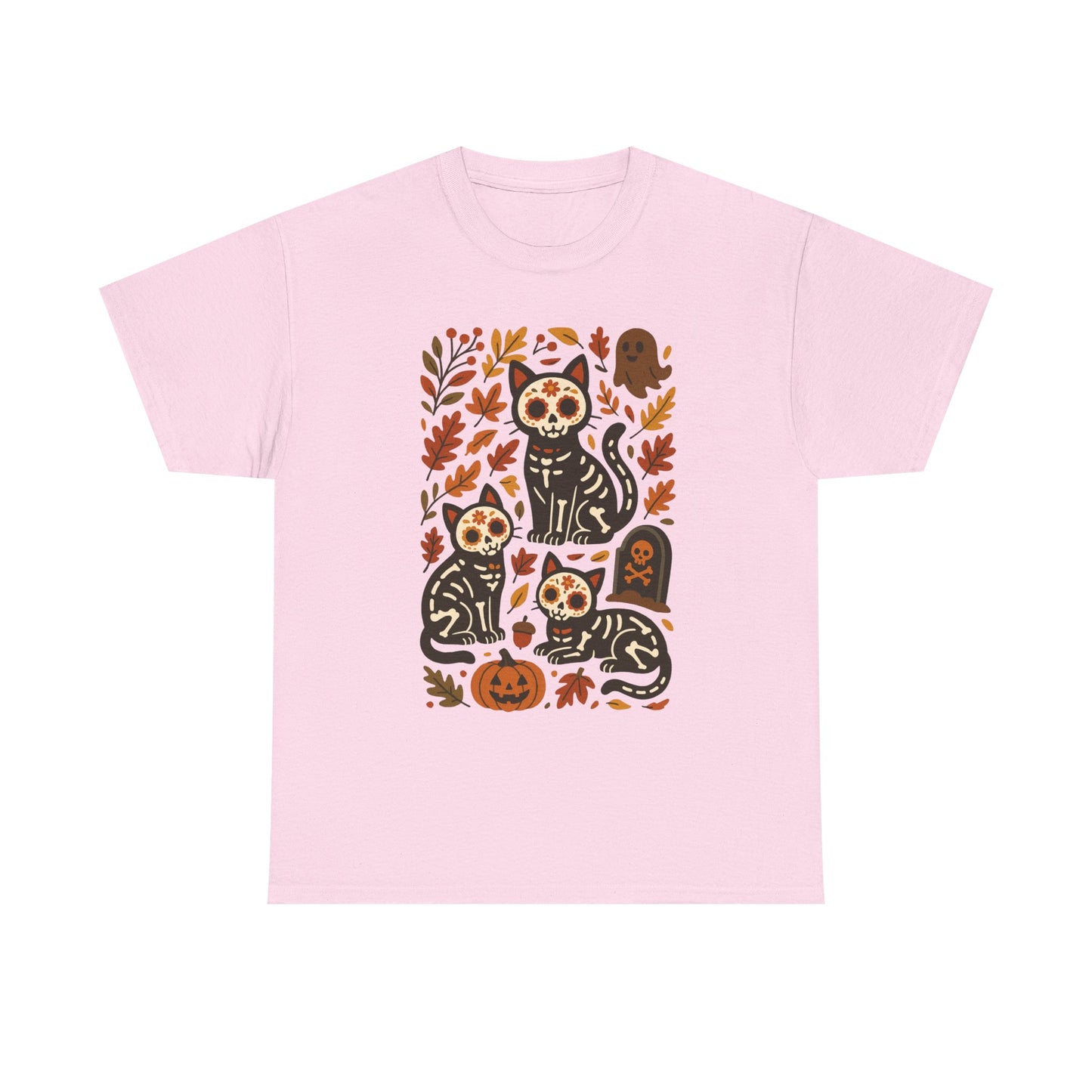 A light pink short-sleeve crewneck t-shirt featuring a central graphic print of three black cats decorated with sugar skull patterns, surrounded by autumn leaves, pumpkins, and a tombstone.