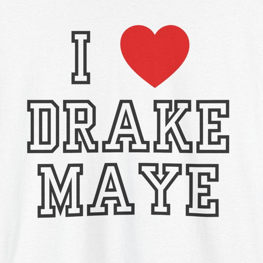 A white short-sleeve crewneck t-shirt featuring a graphic print that reads 'I' followed by a red heart and 'DRAKE MAYE' in black varsity-style lettering with white outlines.