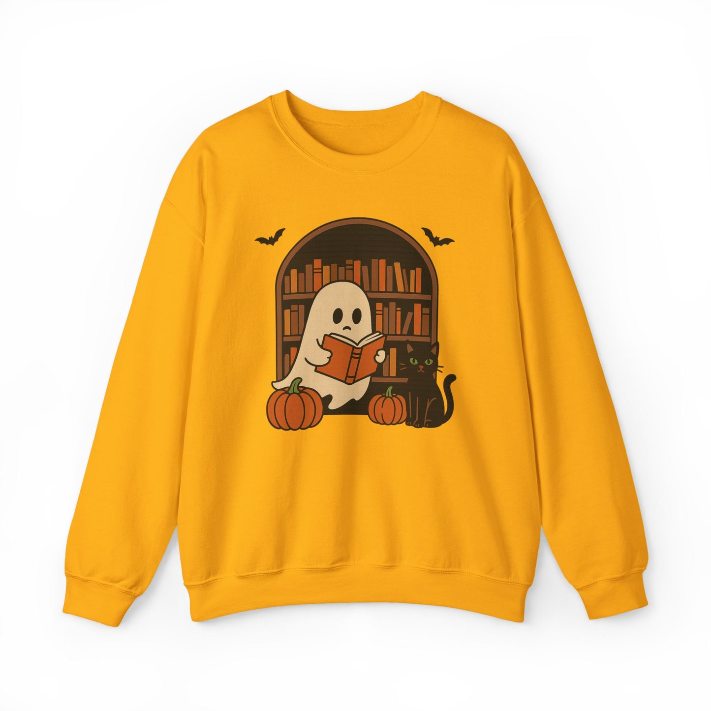 A yellow crewneck sweatshirt featuring a Halloween graphic of a ghost reading a book in front of a bookshelf, with pumpkins, a black cat, and bats.