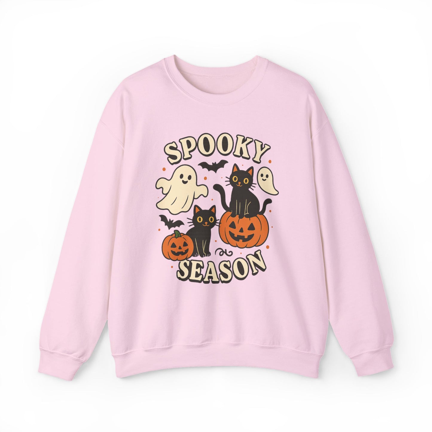 A light pink crewneck sweatshirt featuring a cute Halloween graphic with the words 'SPOOKY SEASON' and illustrations of ghosts, black cats, pumpkins, and bats.