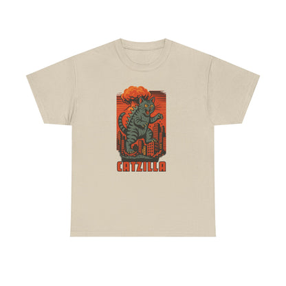 A beige crewneck t-shirt featuring a retro-style graphic of a green cat monster with orange hair standing in front of a red cityscape, with the word 'CATZILLA' printed below.