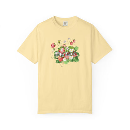 A pale yellow short-sleeve crewneck t-shirt featuring a colorful watercolor graphic of strawberries, green leaves, and the words 'Stay Sweet' in cursive across the chest.