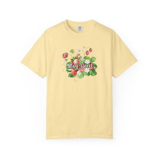 A pale yellow short-sleeve crewneck t-shirt featuring a colorful watercolor graphic of strawberries, green leaves, and the words 'Stay Sweet' in cursive across the chest.