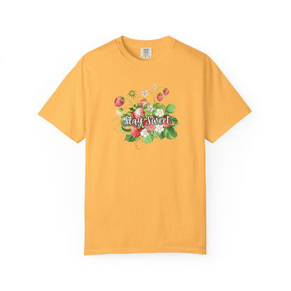 A yellow short-sleeve crewneck t-shirt featuring a colorful floral graphic on the chest with the text 'Stay Sweet' written in white cursive over pink strawberries and green leaves.