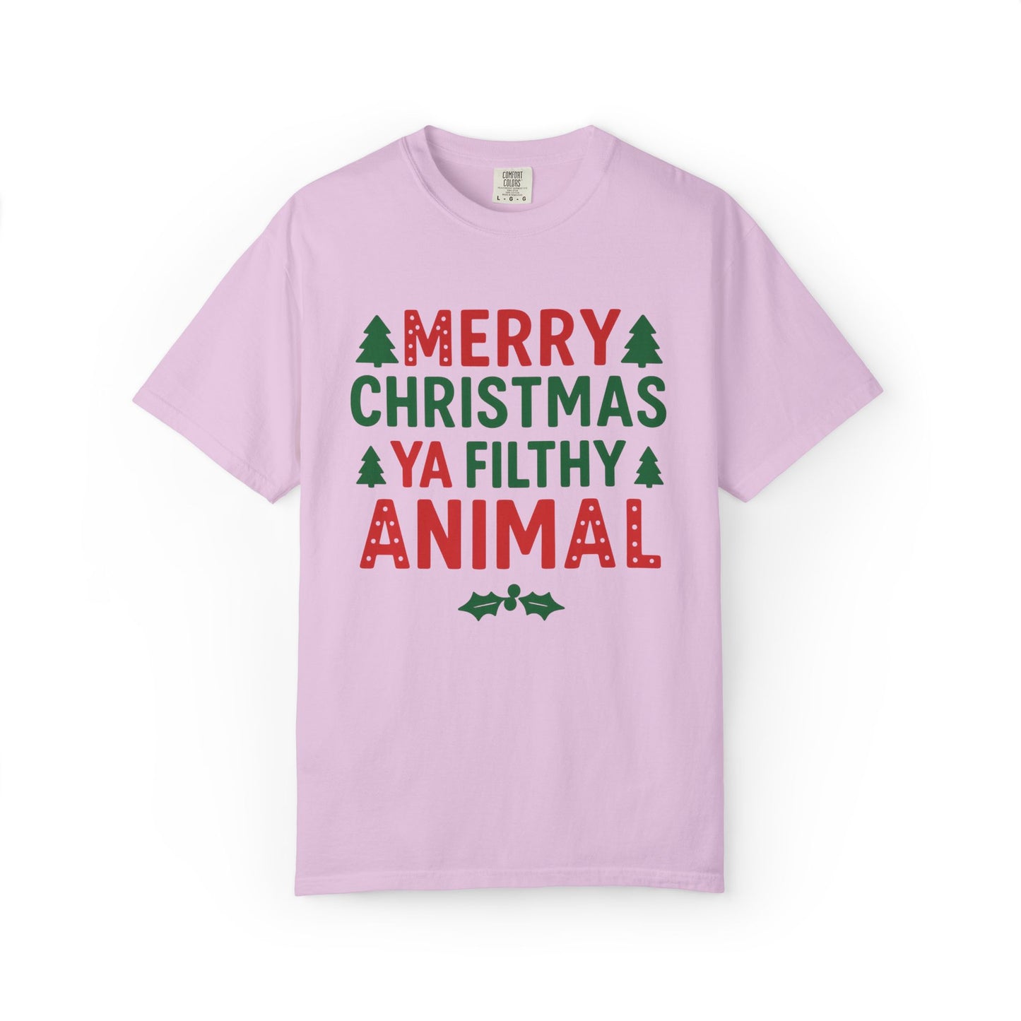 A light pink short-sleeve crewneck t-shirt with a festive graphic on the front that reads 'MERRY CHRISTMAS YA FILTHY ANIMAL' in red and green lettering, accented with small green pine trees and holly leaves, shown on a plain white background.