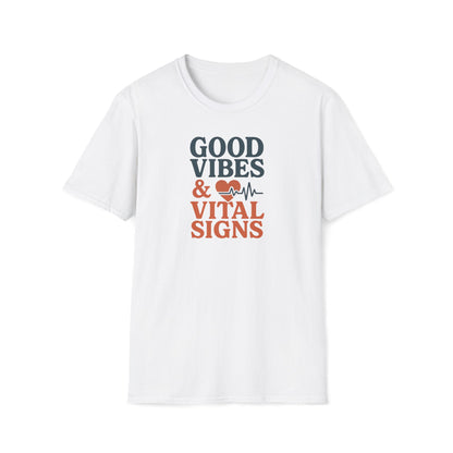 A white short-sleeve crewneck t-shirt with a graphic on the chest that reads 'GOOD VIBES & VITAL SIGNS' in dark gray and orange-red text, accompanied by a heart and heartbeat line icon.