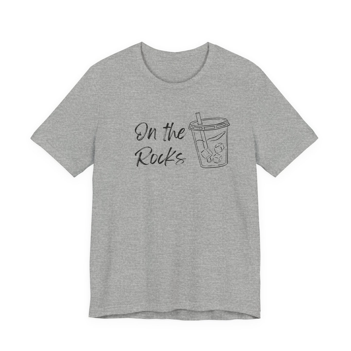 A heather gray short-sleeve t-shirt with a black graphic print on the front that reads 'On the Rocks' next to a simple line drawing of a iced coffee cup, shown against a plain white background.