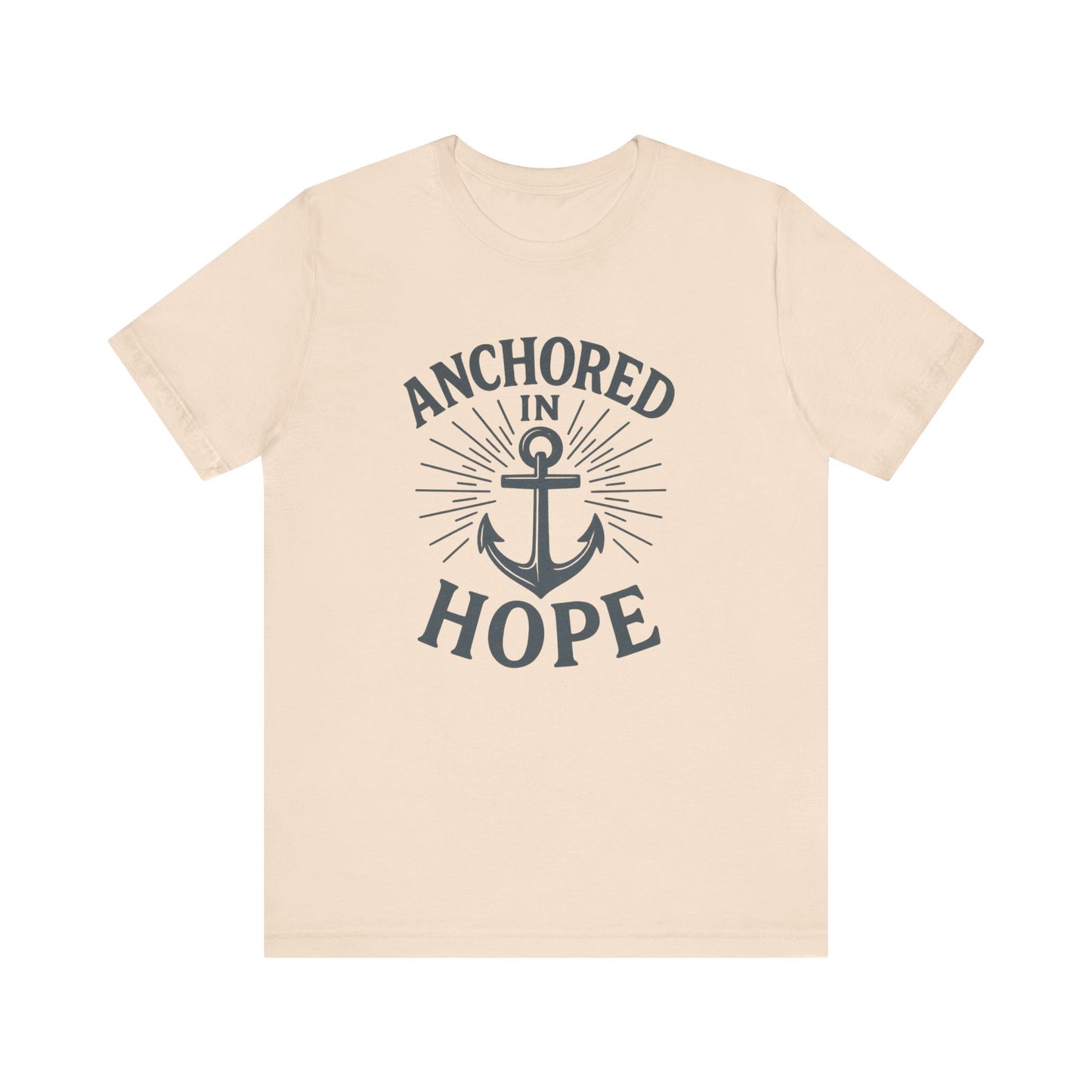 A light beige crewneck t-shirt with a dark navy graphic on the front featuring an anchor and the text 'ANCHORED IN HOPE'.