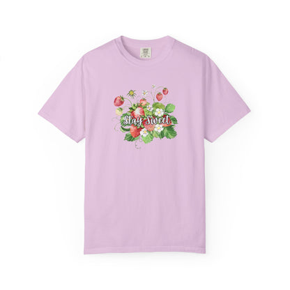A light purple short-sleeve crewneck t-shirt featuring a colorful graphic of strawberries, green leaves, and the words 'Stay Sweet' in white script across the chest, displayed on a clean white background.