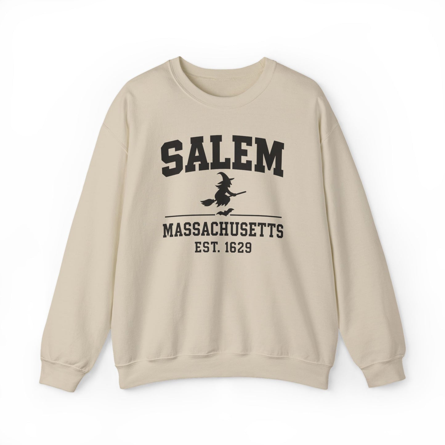 A beige crewneck sweatshirt with a black graphic print on the front reading 'SALEM MASSASETTS EST. 1629' with a witch riding a broomstick, shown against a plain white background.
