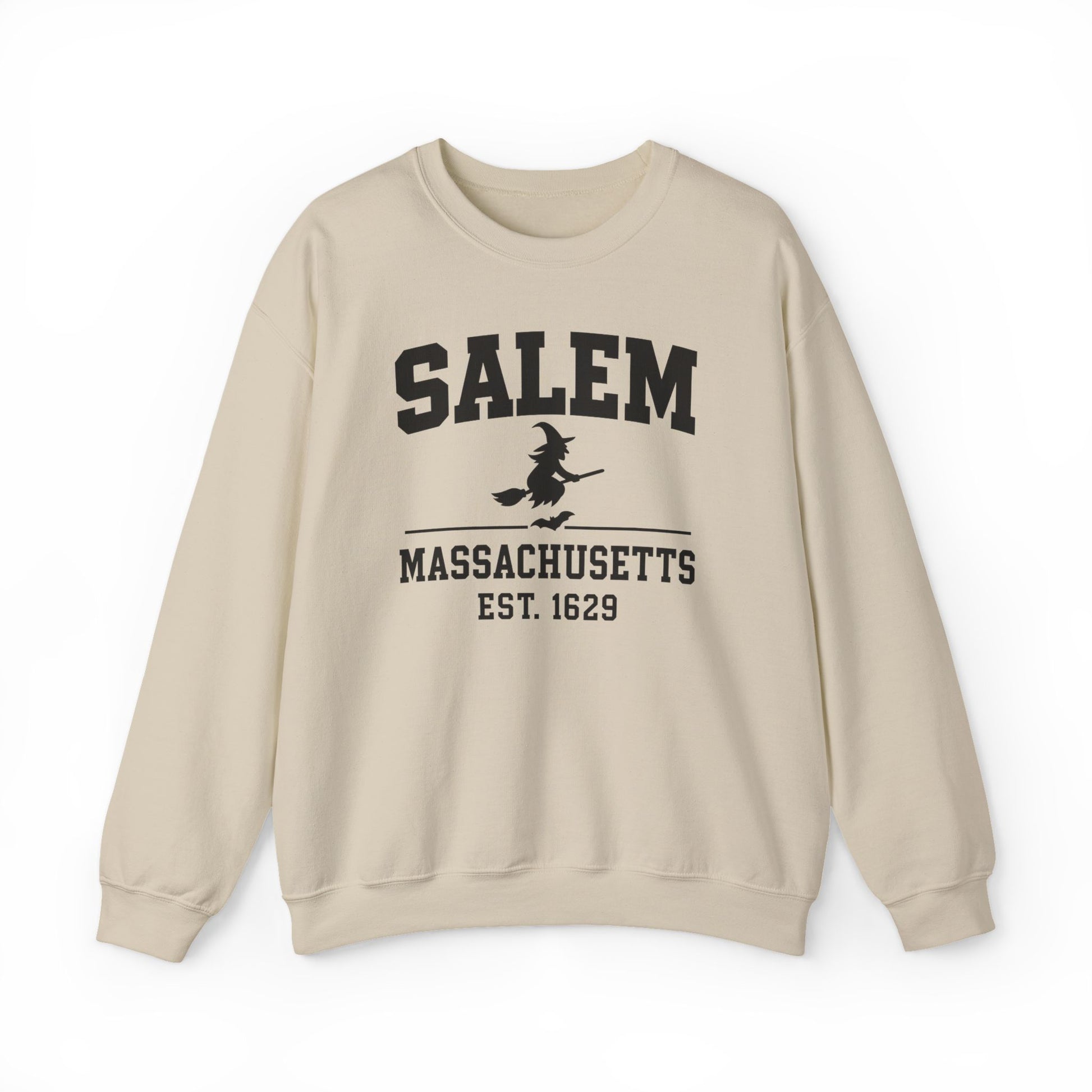 A beige crewneck sweatshirt with a black graphic print on the front reading 'SALEM MASSASETTS EST. 1629' with a witch riding a broomstick, shown against a plain white background.
