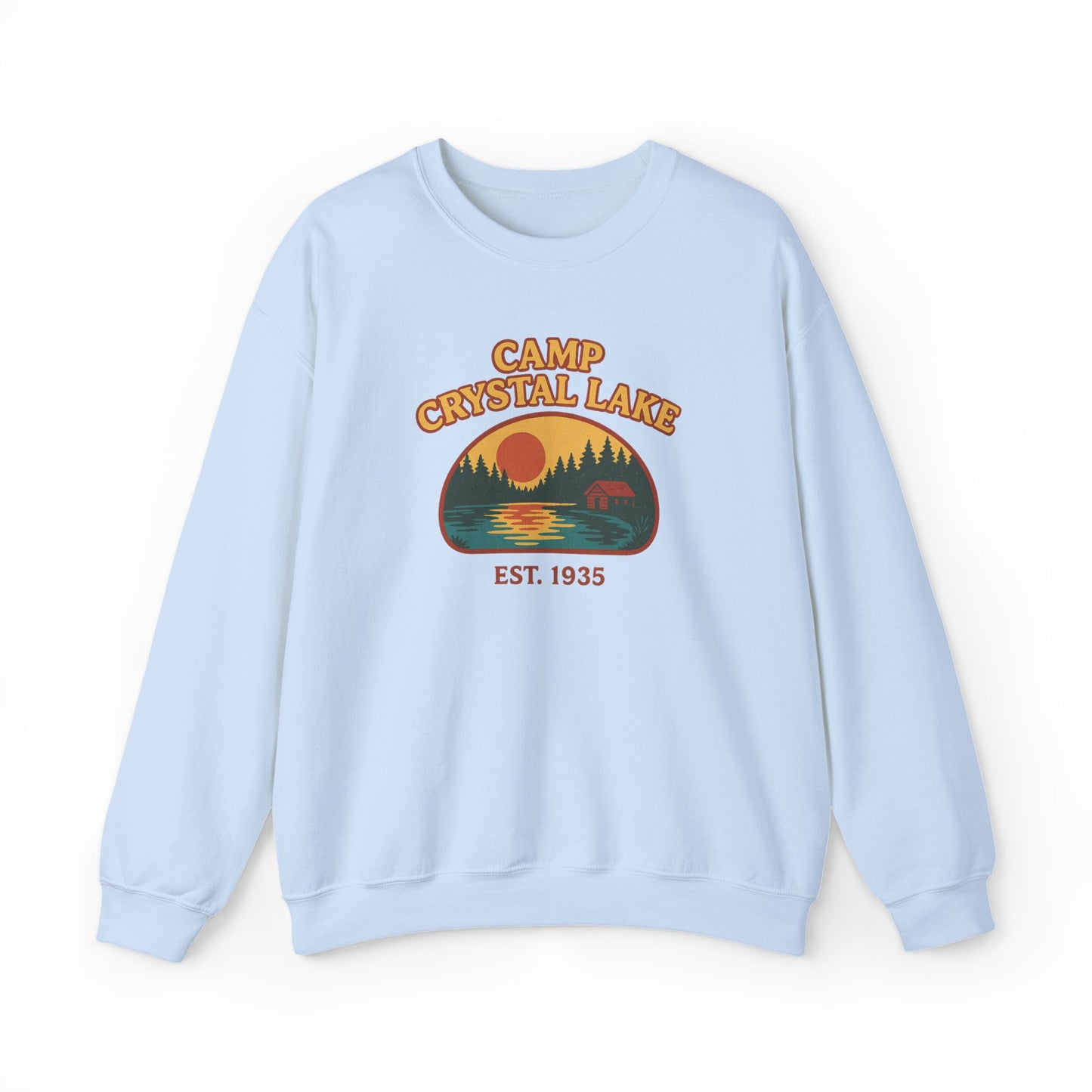 A light blue crewneck sweatshirt featuring a retro-style graphic of a bear at Crystal Lake with the text 'CAMP CRYSTAL LAKE' and 'EST. 1935' on the front, displayed against a plain white background.