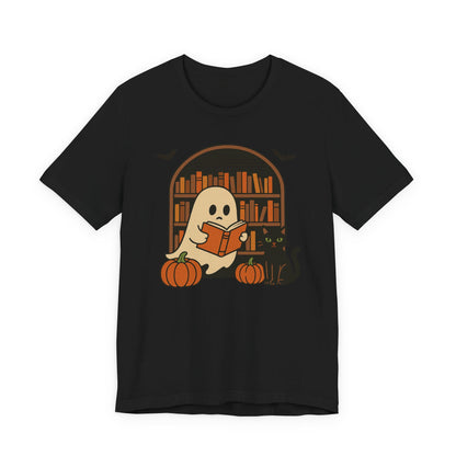 A black short-sleeve crewneck t-shirt featuring a cartoon graphic of a cute ghost reading a book in front of a bookshelf, with two pumpkins at its feet.