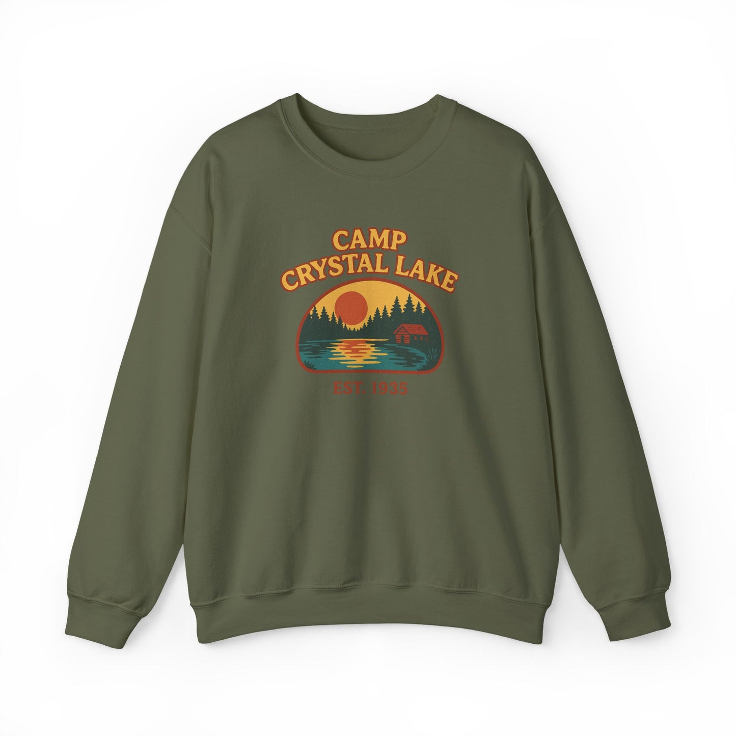 An olive green crewneck sweatshirt featuring a retro-style 'Camp Crystal Lake' graphic on the chest with a sunset, trees, and a deer silhouette.