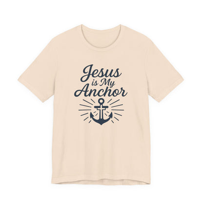 A light beige crewneck t-shirt with a navy blue graphic print that reads 'Jesus is My Anchor' above an anchor illustration, shown on a plain white background.