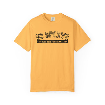 A yellow short-sleeve crewneck t-shirt with a black graphic on the chest that reads 'GO SPORTS' and 'I'M JUST HERE FOR THE SNACKS'.