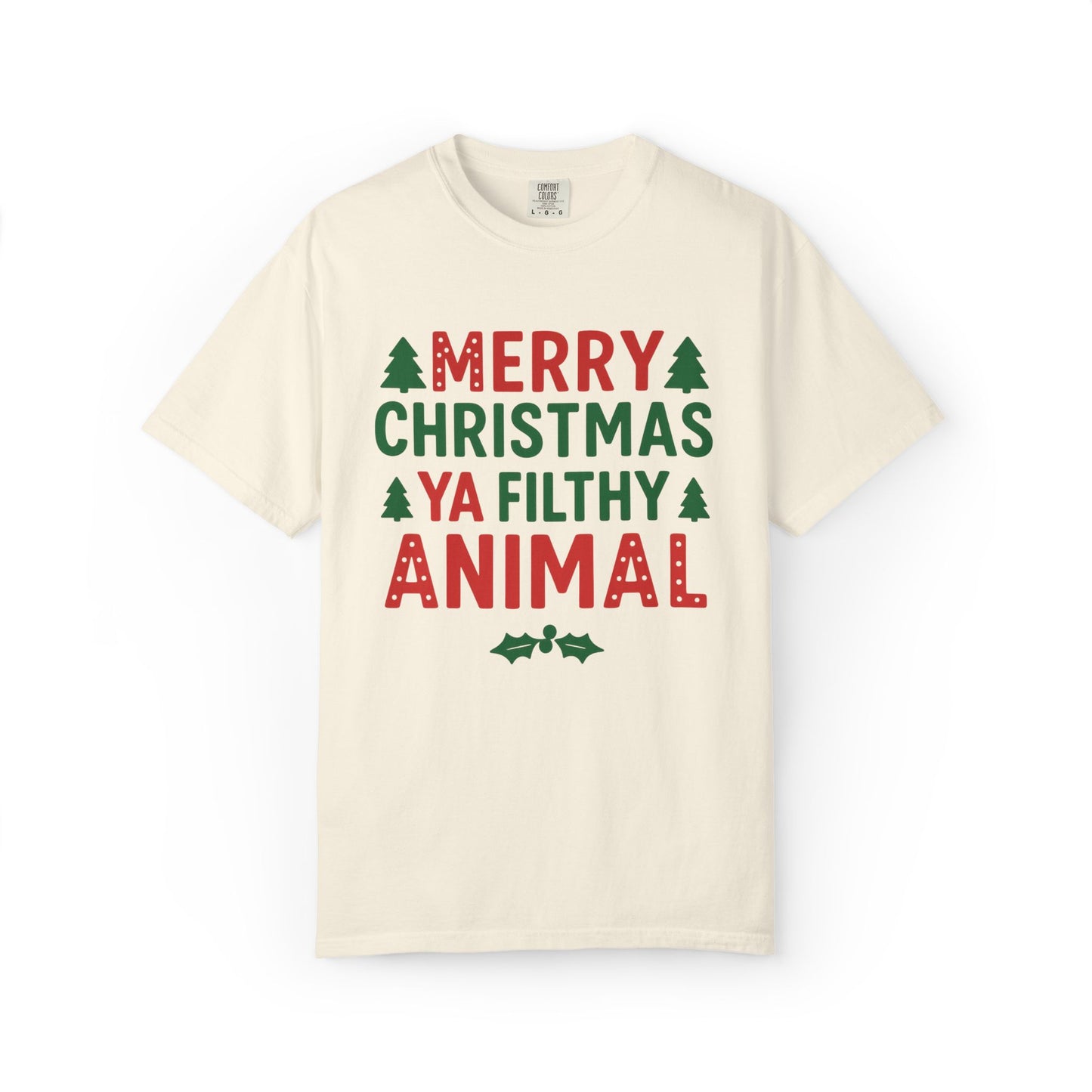 An off-white crewneck t-shirt with a festive graphic print reading 'MERRY CHRISTMAS YA FILTHY ANIMAL' in red and green text with small pine tree and holly accents, displayed on a clean white background.