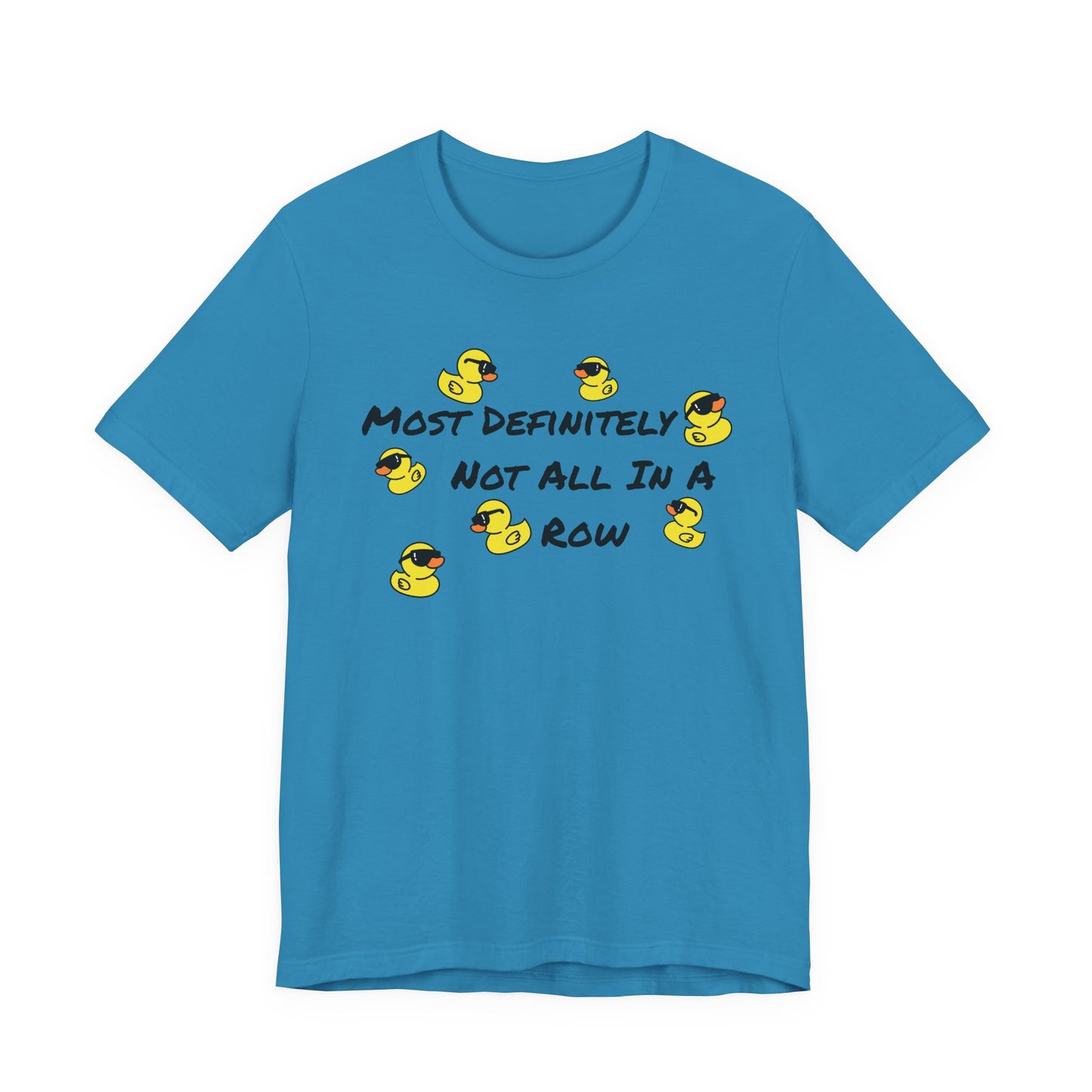 A bright blue short-sleeve t-shirt with a graphic on the chest featuring yellow rubber ducks and the text 'MOST DEFINITELY NOT ALL IN A ROW' in black.