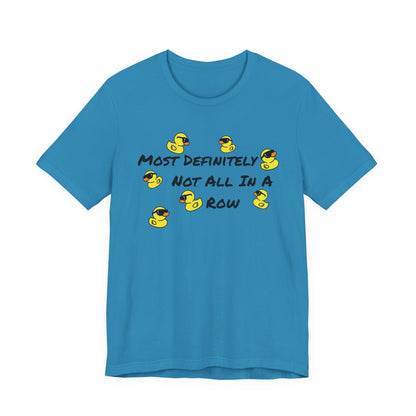 A bright blue short-sleeve t-shirt with a graphic on the chest featuring yellow rubber ducks and the text 'MOST DEFINITELY NOT ALL IN A ROW' in black.
