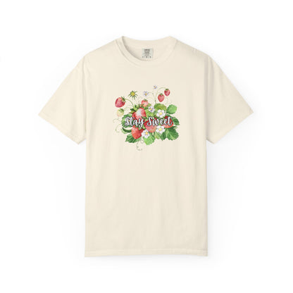 An off-white short-sleeve crewneck t-shirt featuring a watercolor-style graphic of strawberries and green leaves with the text 'Stay Sweet' across the chest, displayed on a clean white background.
