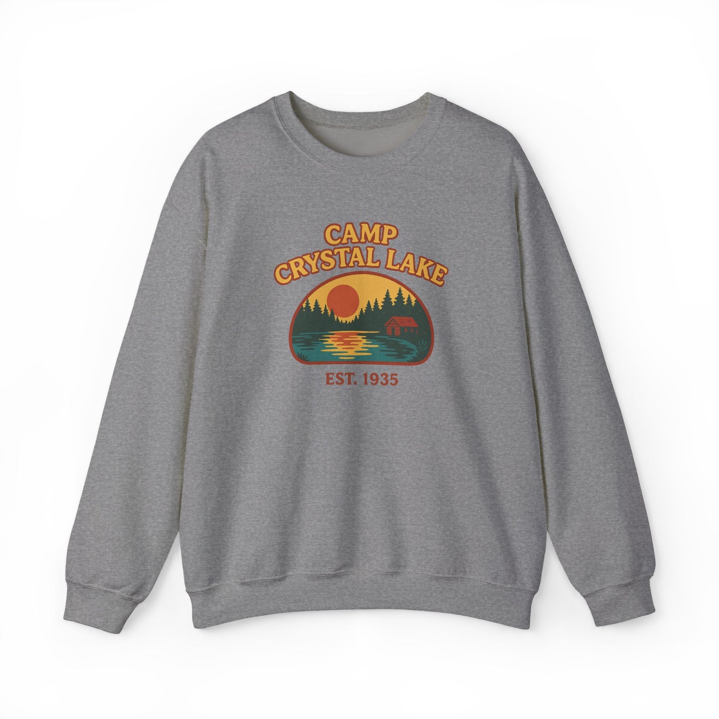 A heather gray crewneck sweatshirt featuring a retro-style 'Camp Crystal Lake' graphic on the chest with a sunset, trees, and a deer silhouette.