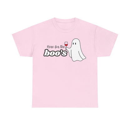 A light pink short-sleeve crewneck t-shirt featuring a graphic on the chest with the text 'Here for the boo's' in black and white bubble letters, next to a cute white cartoon ghost holding a glass of red wine.