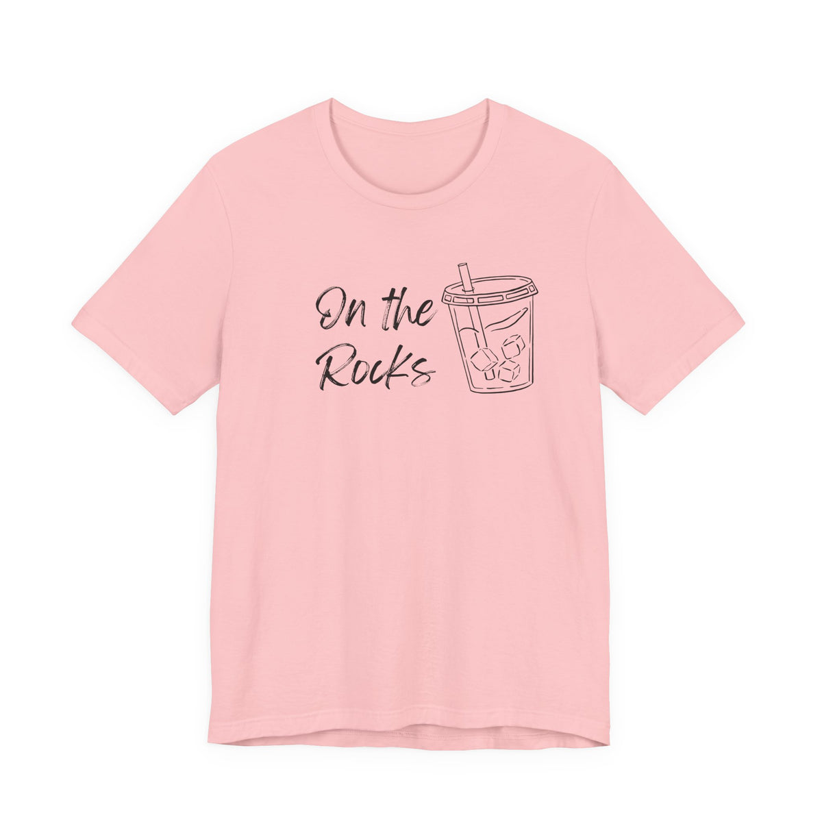 A light pink short-sleeve crewneck t-shirt with a black graphic print on the front that reads 'On the Rocks' next to a simple line drawing of a iced coffee cup, shown against a plain white background.