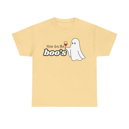A pale yellow short-sleeve t-shirt with a graphic on the chest that reads 'Here for the boo's' next to a cartoon ghost holding a glass of red wine, shown on a plain white background.