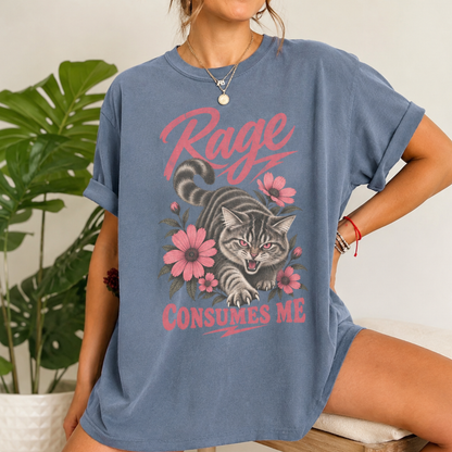 A woman wearing an oversized slate blue graphic t-shirt with a cat illustration and the text 'Rage Consumes Me'.
