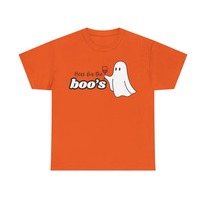 An orange short-sleeve crewneck t-shirt featuring a Halloween graphic on the chest with the text 'Here for the boo's' and a cartoon ghost holding a wine glass.