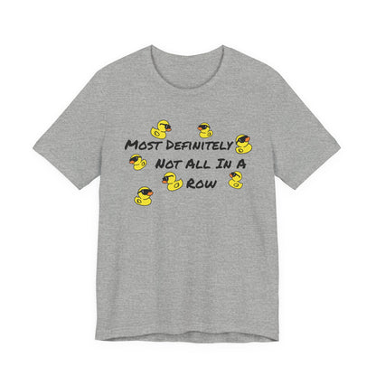 A heather gray short-sleeve t-shirt with a graphic print featuring yellow rubber ducks and the text 'MOST DEFINITELY NOT ALL IN A ROW' in black.