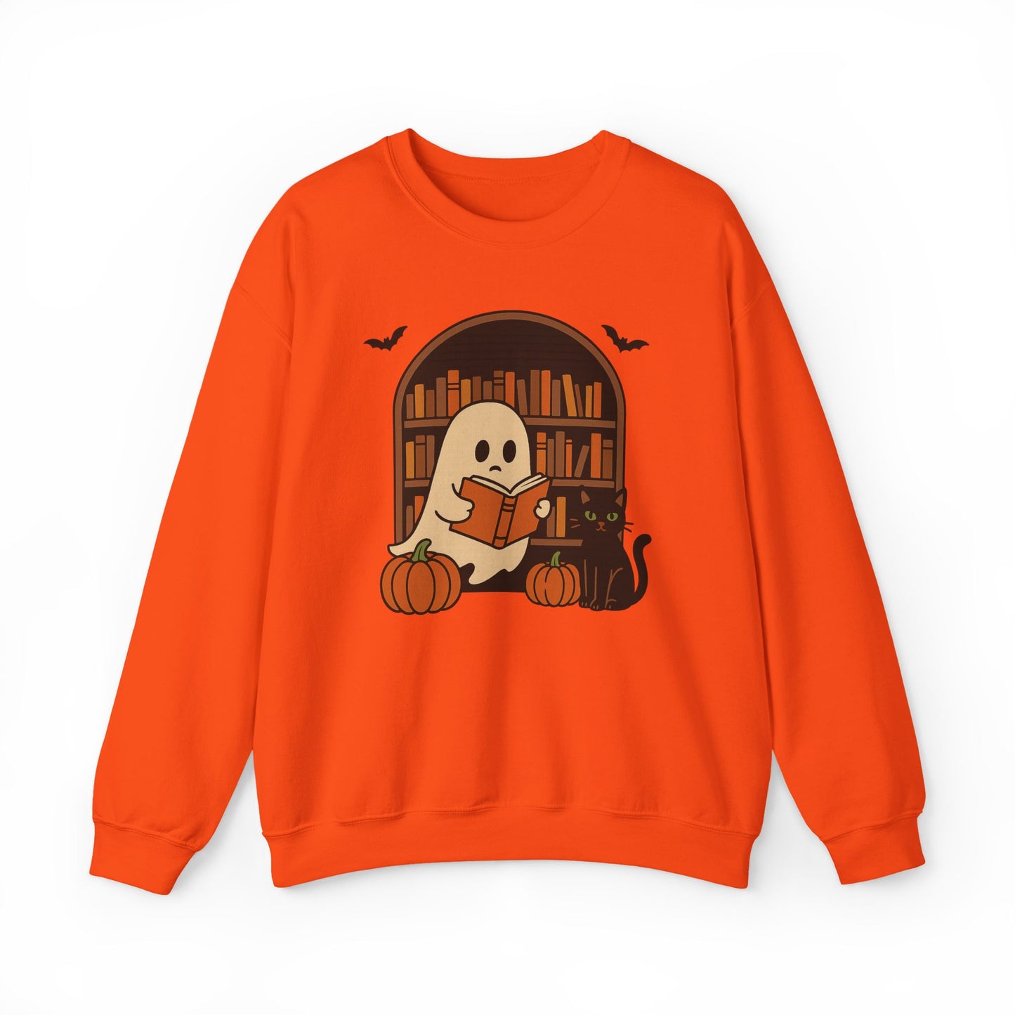An orange crewneck sweatshirt featuring a Halloween graphic of a cute cartoon ghost reading a book in front of a bookshelf, with pumpkins, a black cat, and bats.