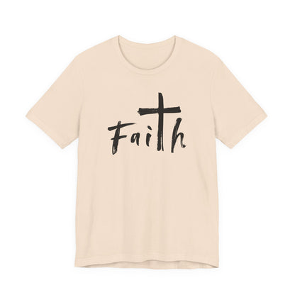 A light beige crewneck t-shirt featuring a black graphic print on the front that reads 'Faith' with a cross integrated into the letter 'i'.