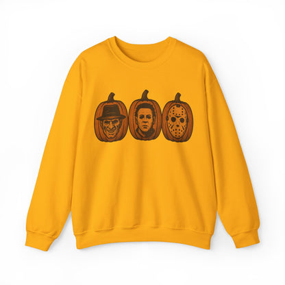 A yellow crewneck sweatshirt featuring a graphic print of three horror movie pumpkin pumpkins on the chest, displayed against a plain white background.