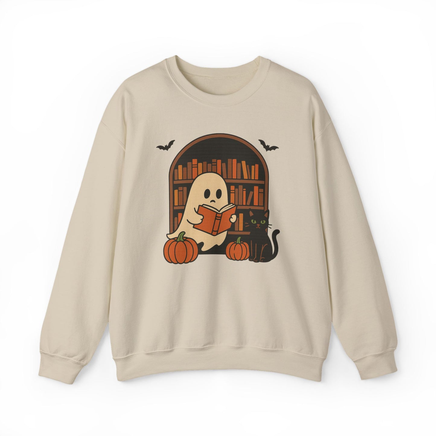 A beige crewneck sweatshirt featuring a Halloween-themed graphic of a ghost reading a book in front of a bookshelf, with pumpkins, a black cat, and bats.