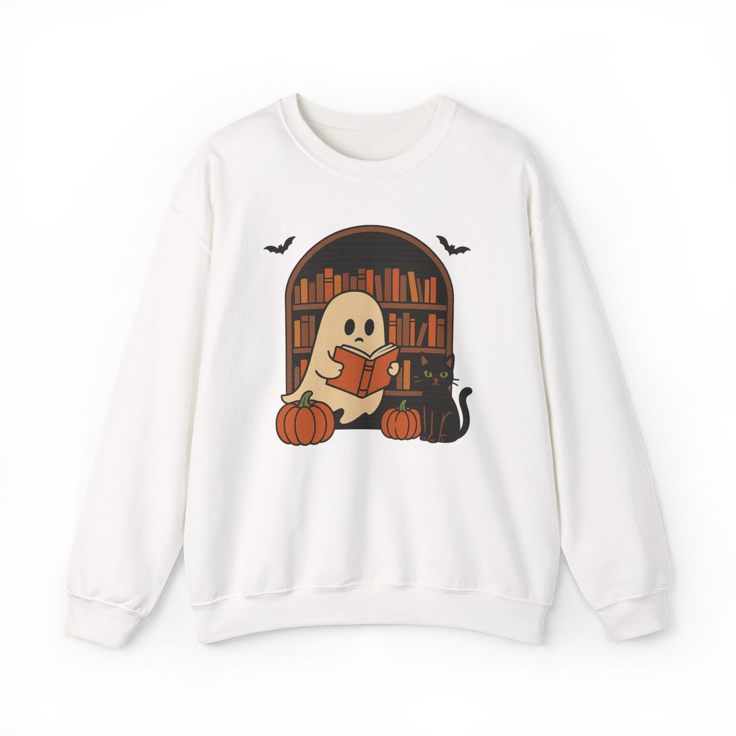 A white crewneck sweatshirt featuring a cute Halloween graphic of a ghost reading a book in front of a bookshelf, with pumpkins, a black cat, and bats.
