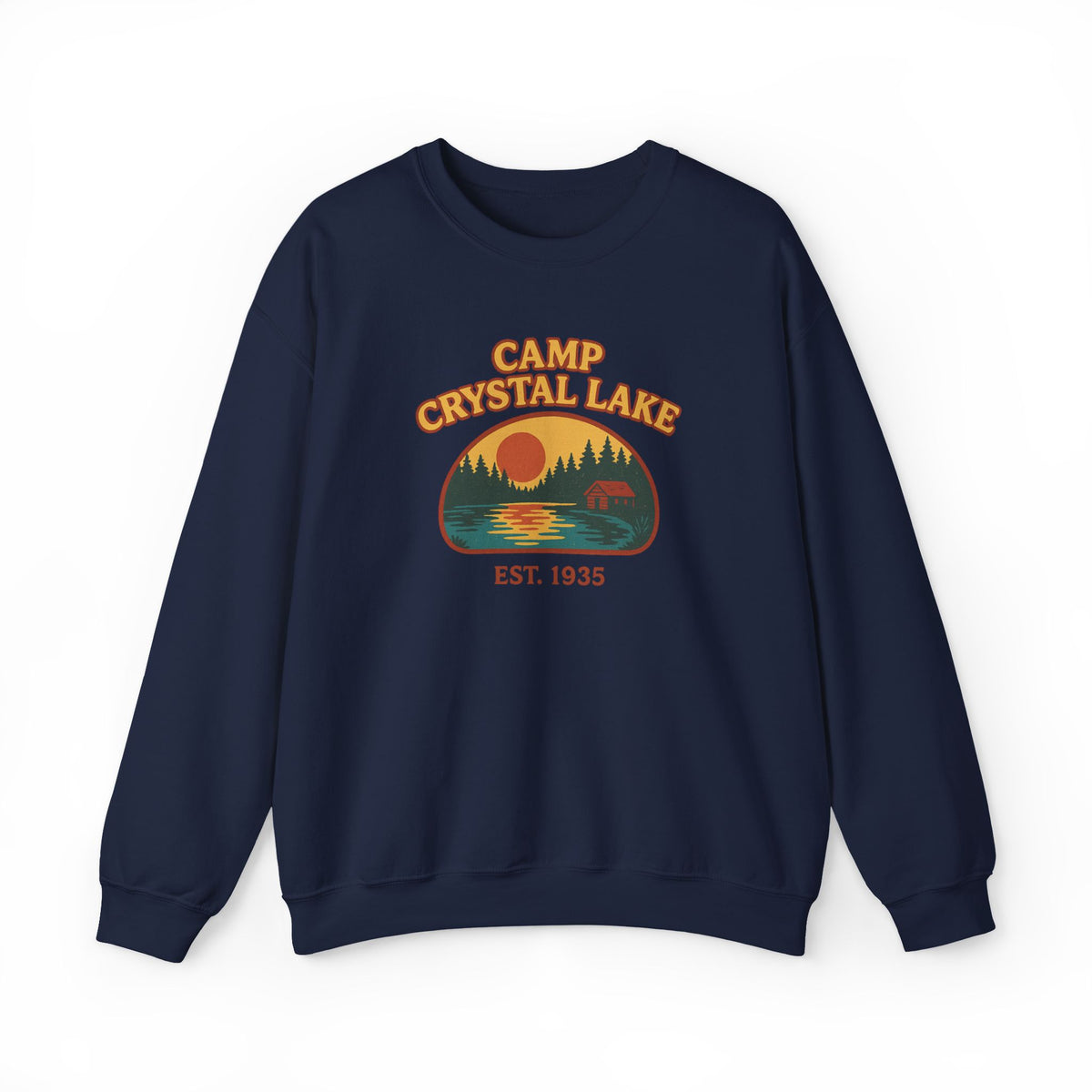 A navy blue crewneck sweatshirt featuring a retro-style 'Camp Crystal Lake' graphic on the chest with a sunset, trees, and a bear, set against a plain white background.