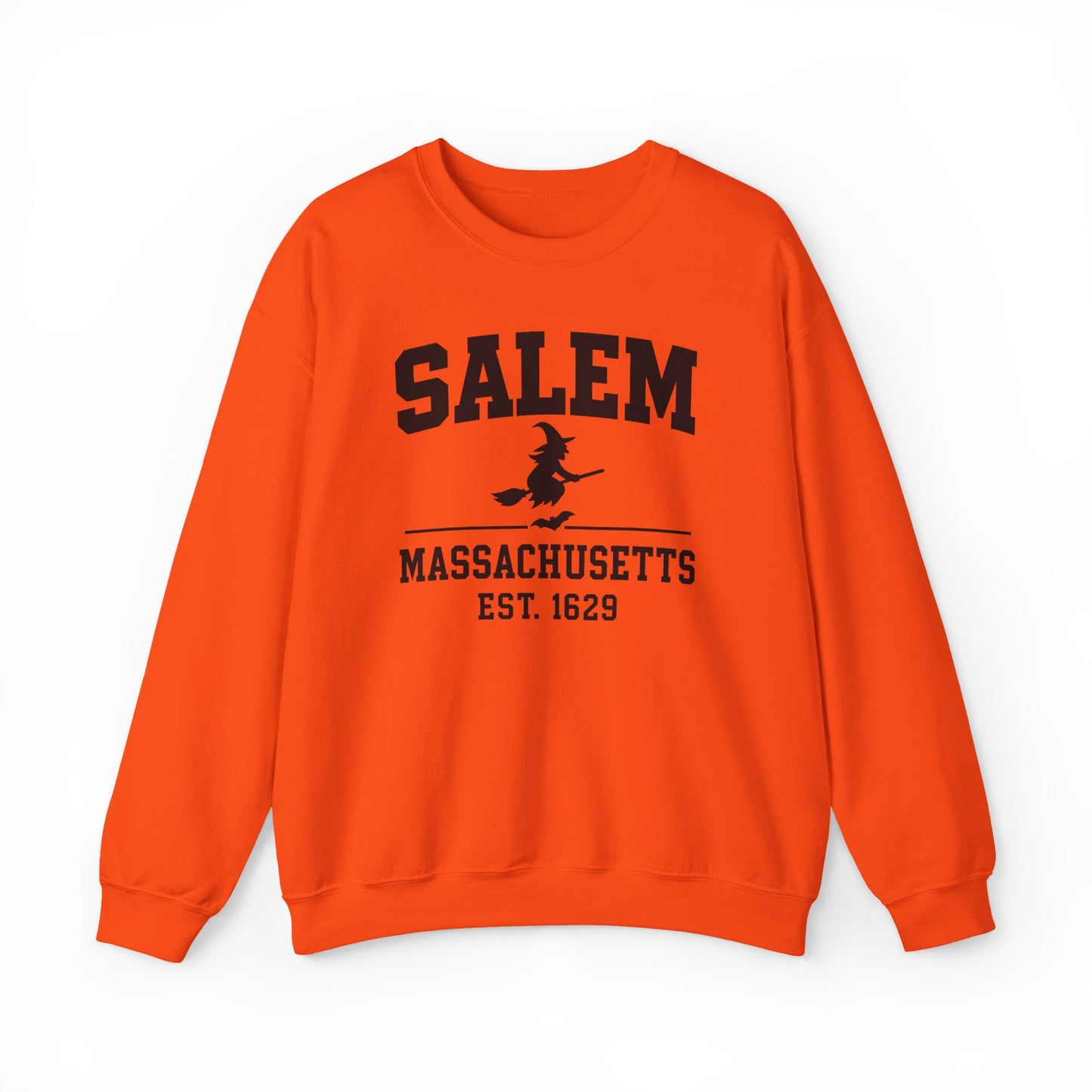 Bright orange crewneck sweatshirt with a black graphic print on the front reading 'SALEM MASSACHUSETTS EST. 1629' with a witch riding a broomstick, shown on a plain white background.