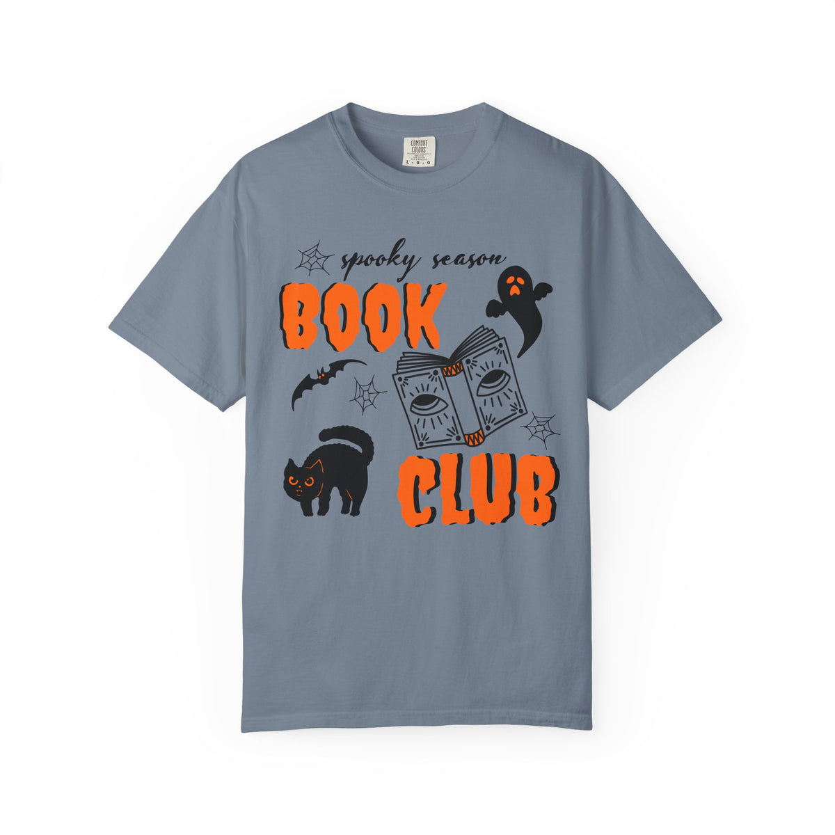 A slate blue crewneck t-shirt featuring a 'spooky season BOOK CLUB' graphic on the front with orange text, a black cat, a ghost, a bat, and a book illustration, displayed on a clean white background.