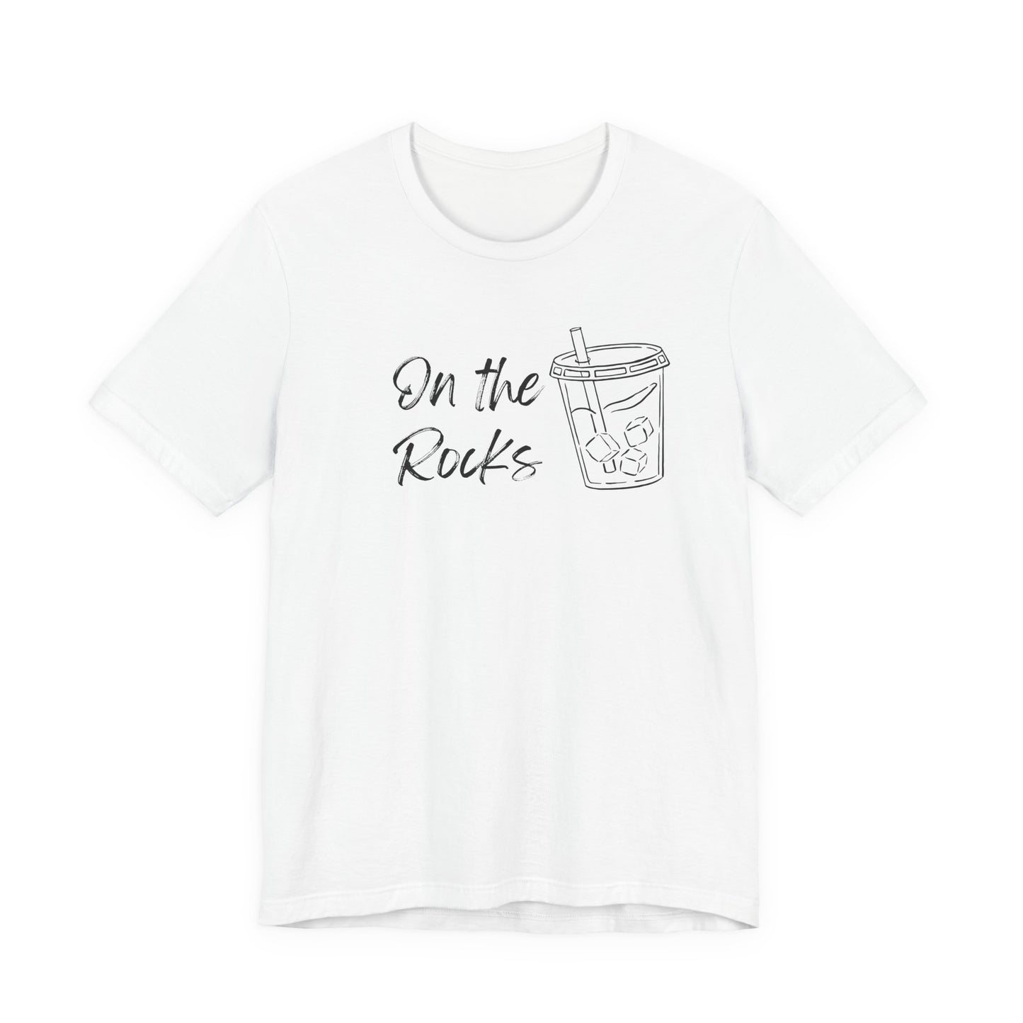 A white short-sleeve crewneck t-shirt featuring a black graphic print on the front with the text 'On the Rocks' next to a simple line drawing of a iced coffee cup.