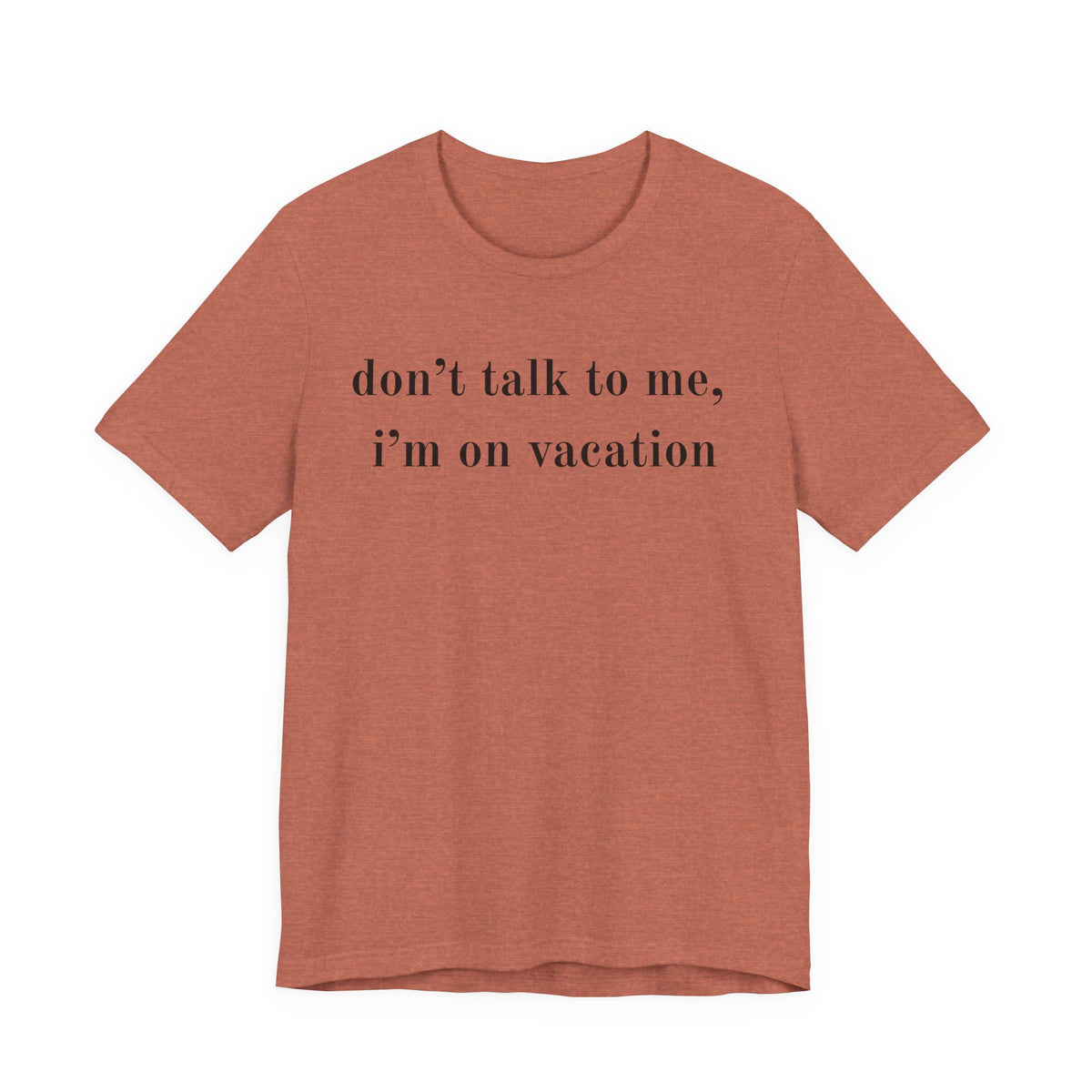 A heathered terracotta short-sleeve t-shirt with the text 'don't talk to me, i'm on vacation' printed in black serif font across the chest, displayed on a solid white background.