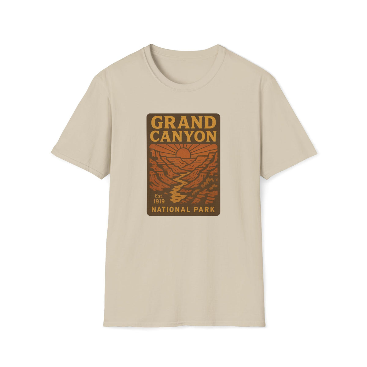 A beige crewneck t-shirt featuring a rectangular graphic print on the chest that reads 'GRAND CANYON NATIONAL PARK' in yellow and brown over an orange canyon landscape illustration.