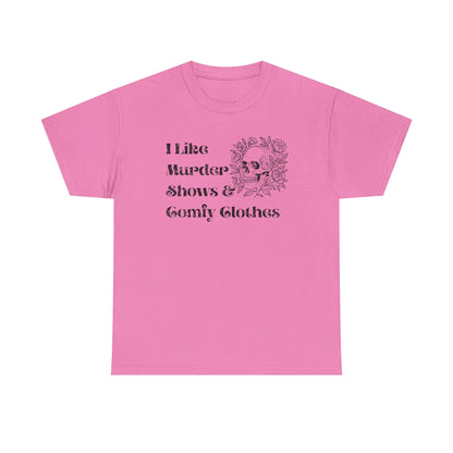 A pink short-sleeve crewneck t-shirt with a black graphic print on the front that reads 'I Like Murder Shows & Gomf Clothes' alongside a skull and roses illustration.