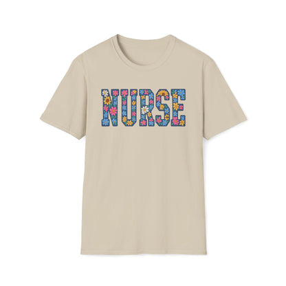 A beige short-sleeve crewneck t-shirt featuring the word 'NURSE' printed across the chest in a colorful floral patterned font, displayed on a clean white background.
