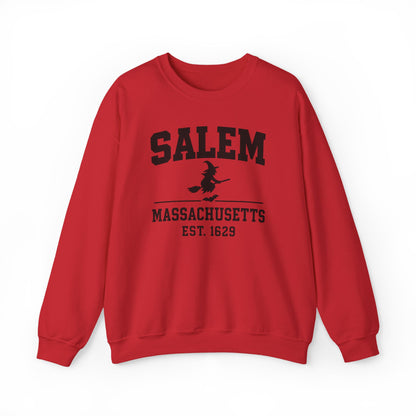 A red crewneck sweatshirt featuring a black distressed graphic print on the front that reads 'SALEM MASSASETTS EST. 1629' with a silhouette of a witch riding a broomstick.