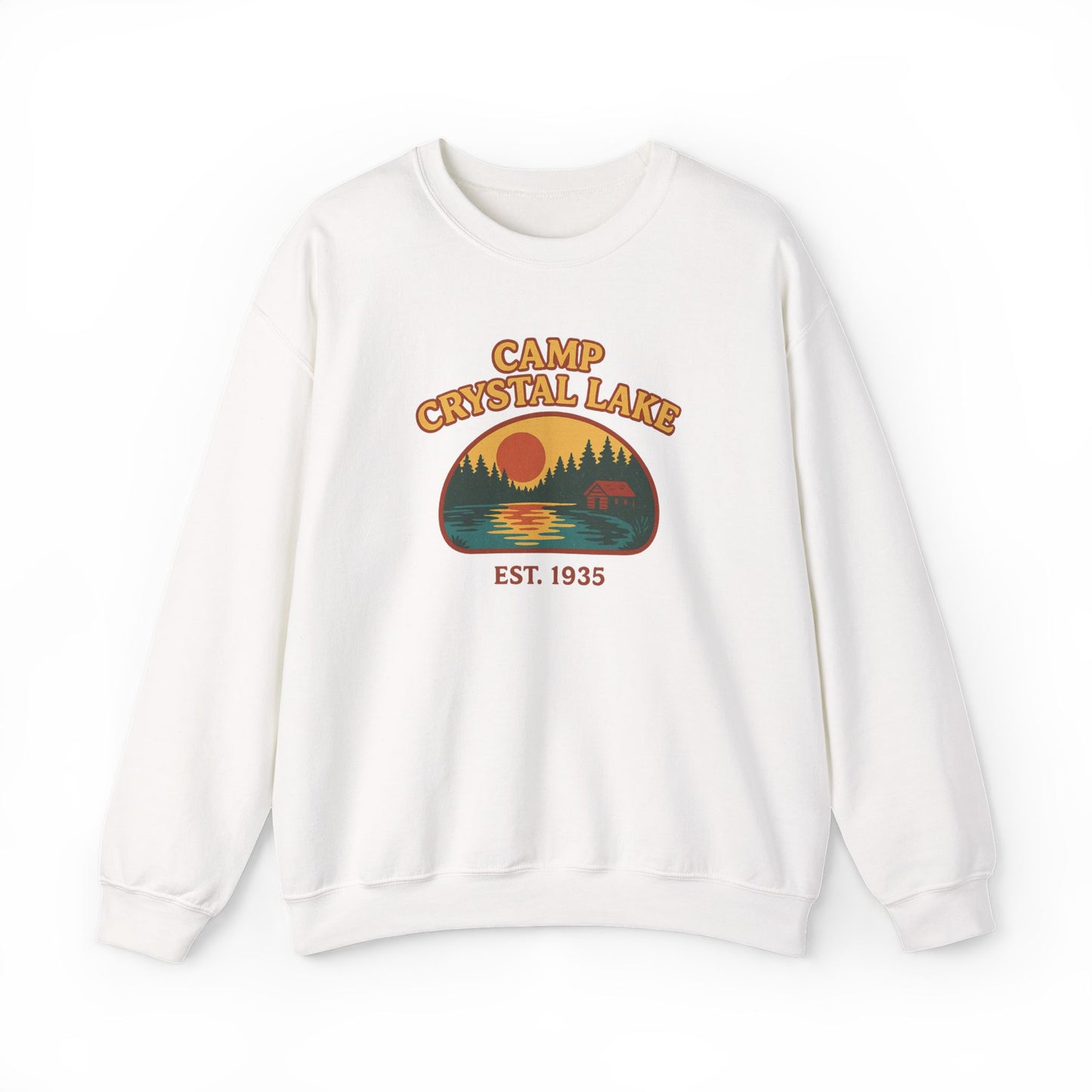 A white crewneck sweatshirt featuring a retro-style graphic print on the chest that reads 'CAMP CRYSTAL LAKE' and 'EST. 1935' with a sunset lake scene and bear illustration.