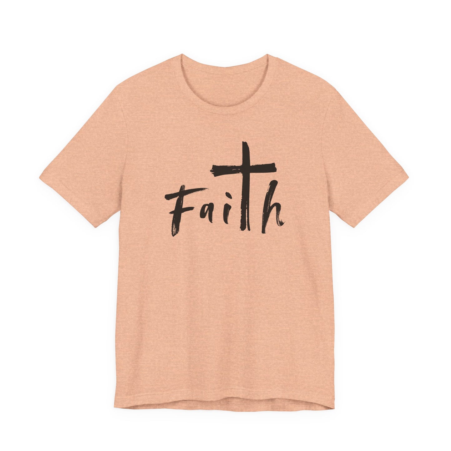 A heather peach short-sleeve t-shirt with a black graphic on the chest featuring a cross and the word 'Faith' in a handwritten font, displayed on a solid white background.