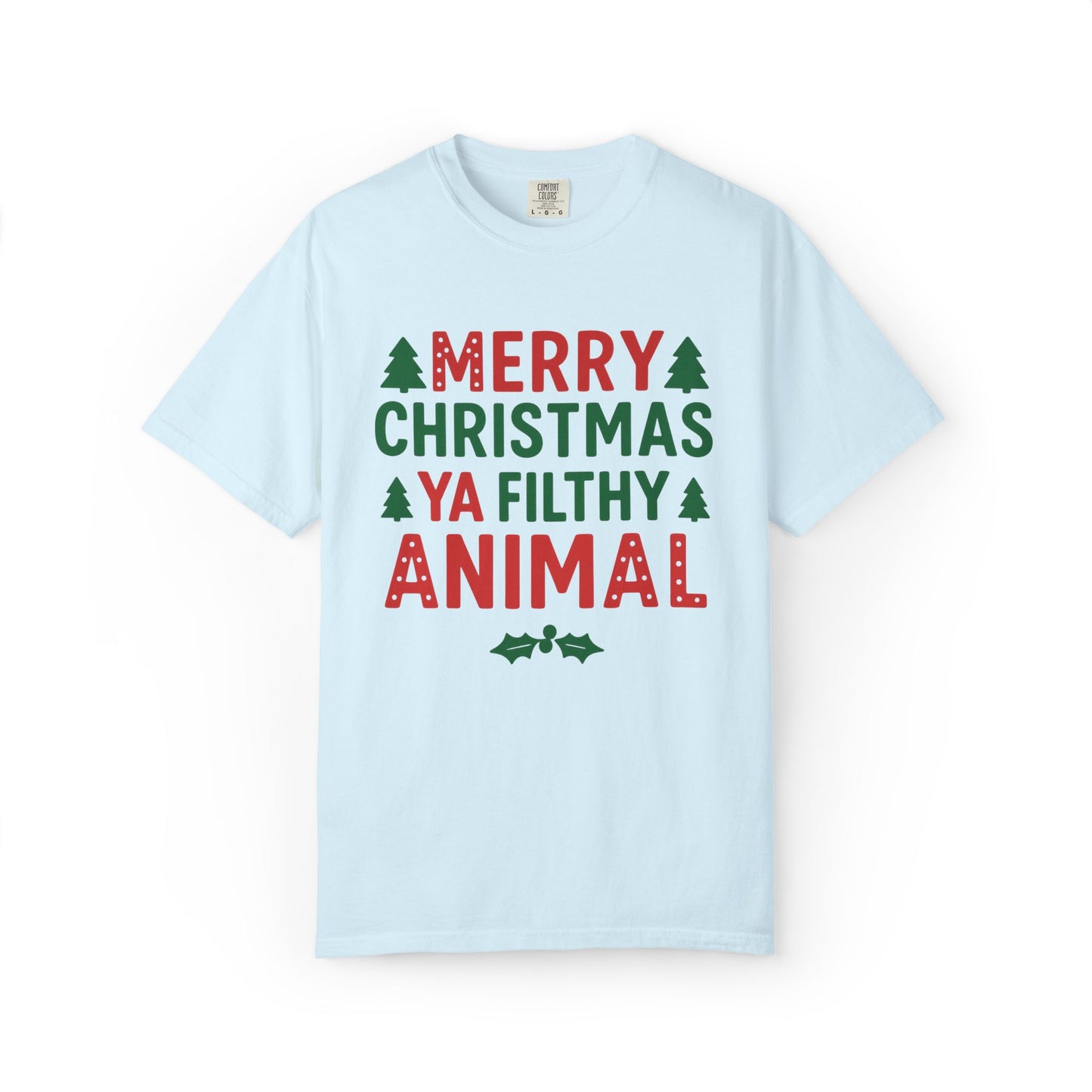 A light blue short-sleeve crewneck t-shirt with a festive graphic print reading 'MERRY CHRISTMAS YA FILTHY ANIMAL' in red and green lettering, accented with small green pine trees and holly leaves, displayed on a clean white background.