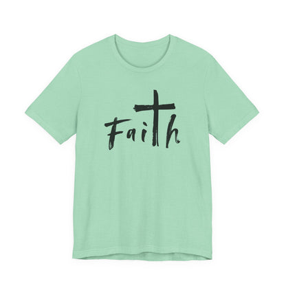 A mint green short-sleeve t-shirt with a black graphic on the chest featuring a cross and the word 'Faith' in a handwritten font, displayed on a solid white background.
